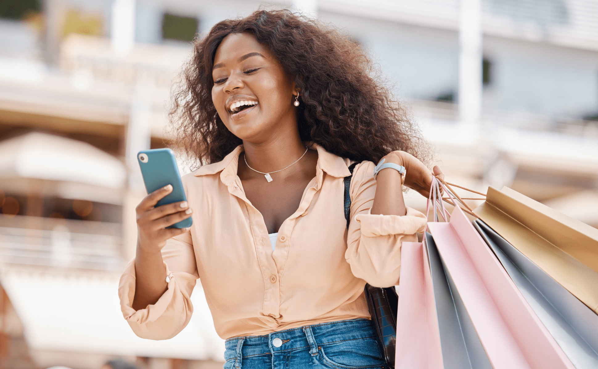 Girl paying at mall with shopping bags