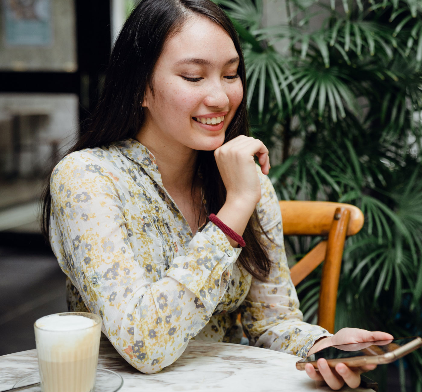 Woman drinking cofffee while reviewing finances.